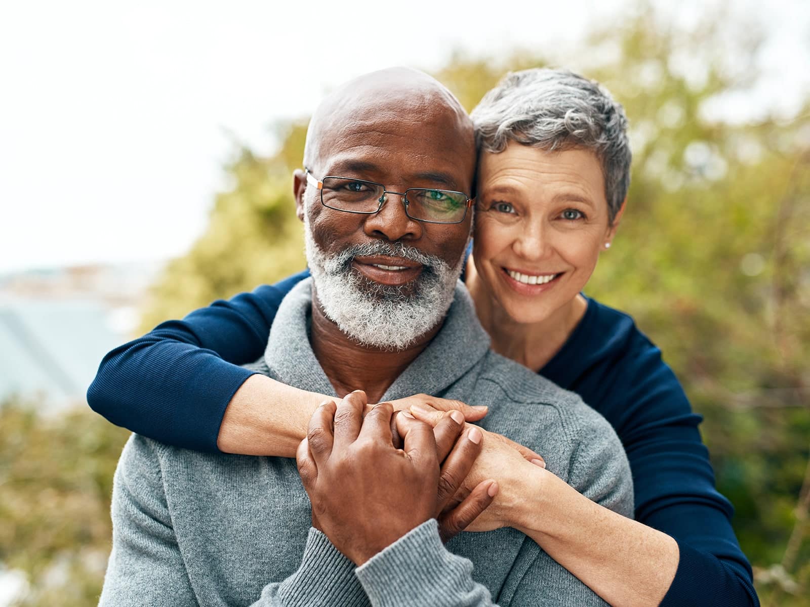 Mature couple smiling after receiving a restorative dentistry treatment