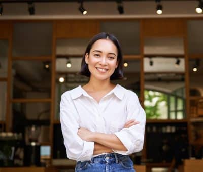 woman smiling in front of restaurant